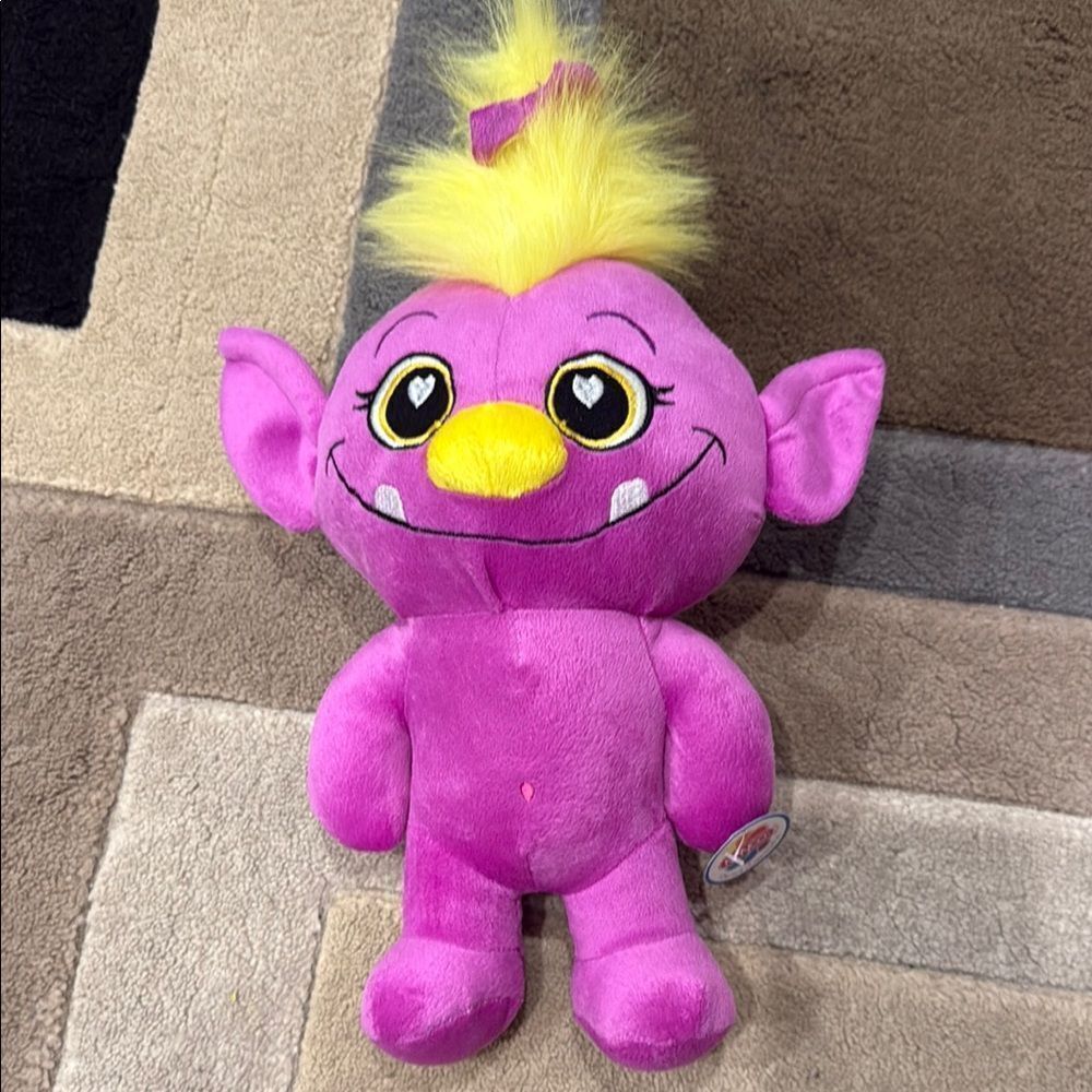Pink and Yellow Stuffed Animal with Spiky Hair
